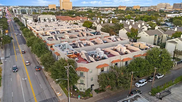 a view of a livingroom with a flat screen tv wooden floor and a ceiling fan