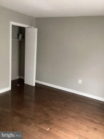 a view of an empty room and wooden floor