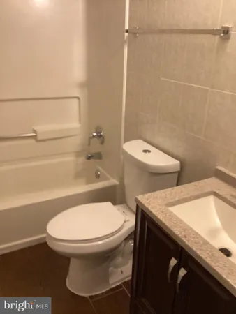 a bathroom with a toilet a sink and bathtub