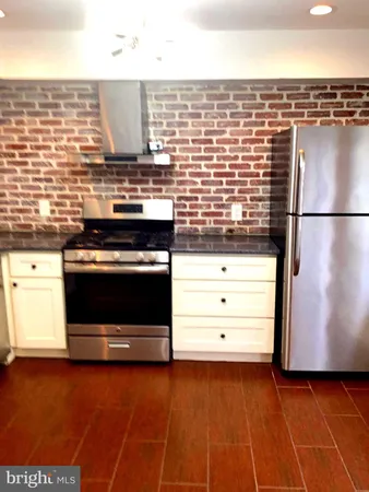 a kitchen with stainless steel appliances a stove and a refrigerator