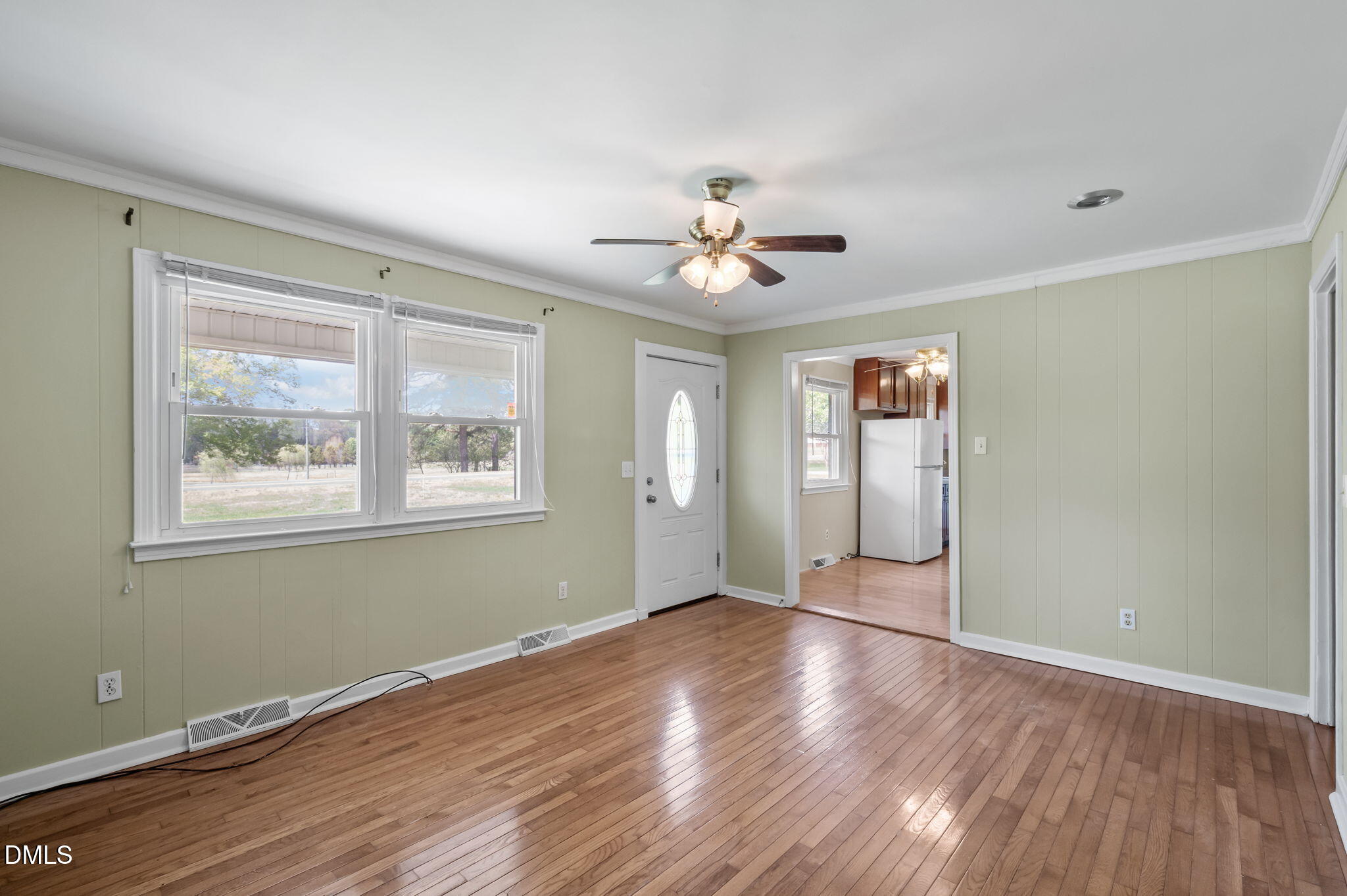 95 Harold Gill Road Roxboro, NC 27574 - Photo 9 of 53 a view of an empty room with window and wooden floor