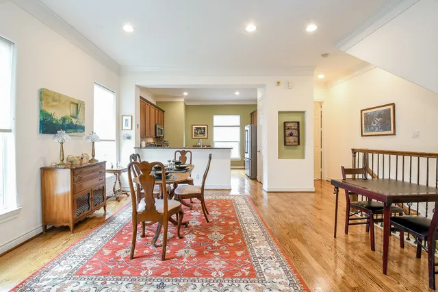 a view of a a dining room with furniture window and wooden floor