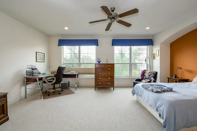 a bedroom with two beds and a large window