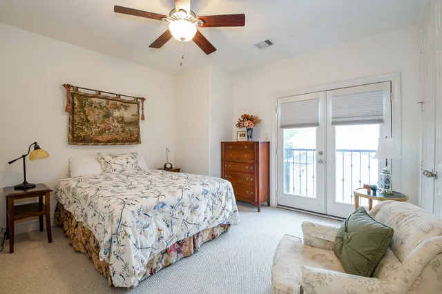 a bedroom with a large bed and a window