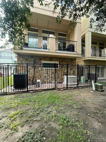 a view of a cars park in front of a building