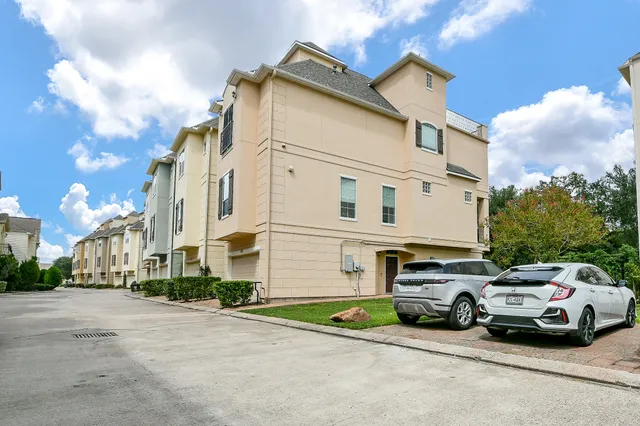a view of a patio with dining table and chairs