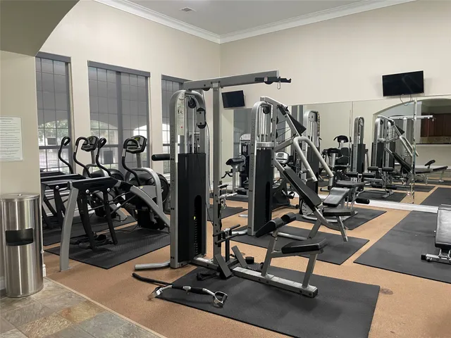 a living room with furniture and large windows