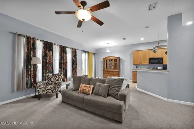 a living room with furniture and large windows