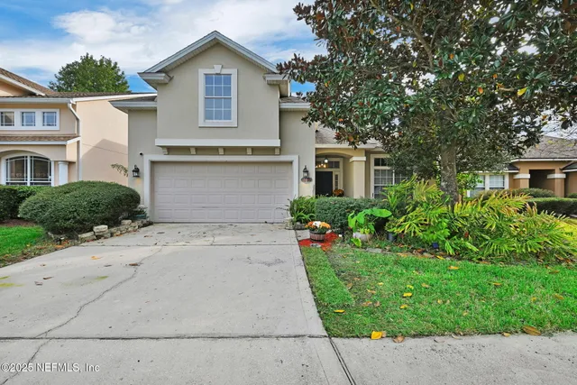 a view of a house with a yard and plants