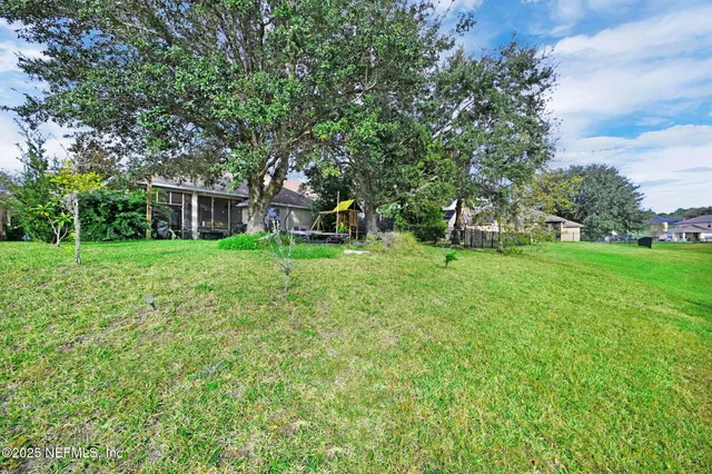 a view of a house with a yard and sitting area