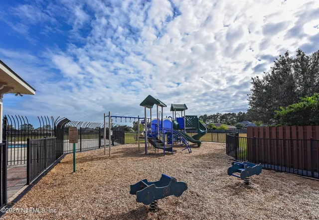 a view of a park with iron fence