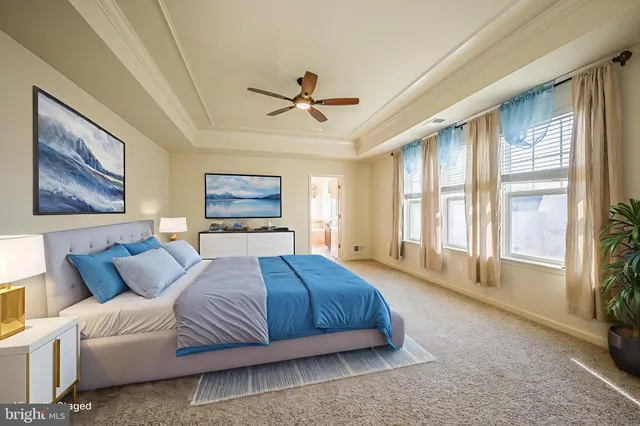 a spacious bedroom with a large bed and a window