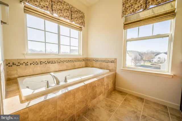 a bath tub sitting next to a window