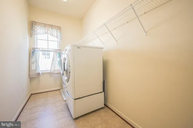 a living room with furniture and a book shelf
