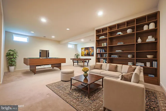 an empty room with a chandelier fan and windows