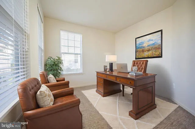 a living room with furniture a window and a table