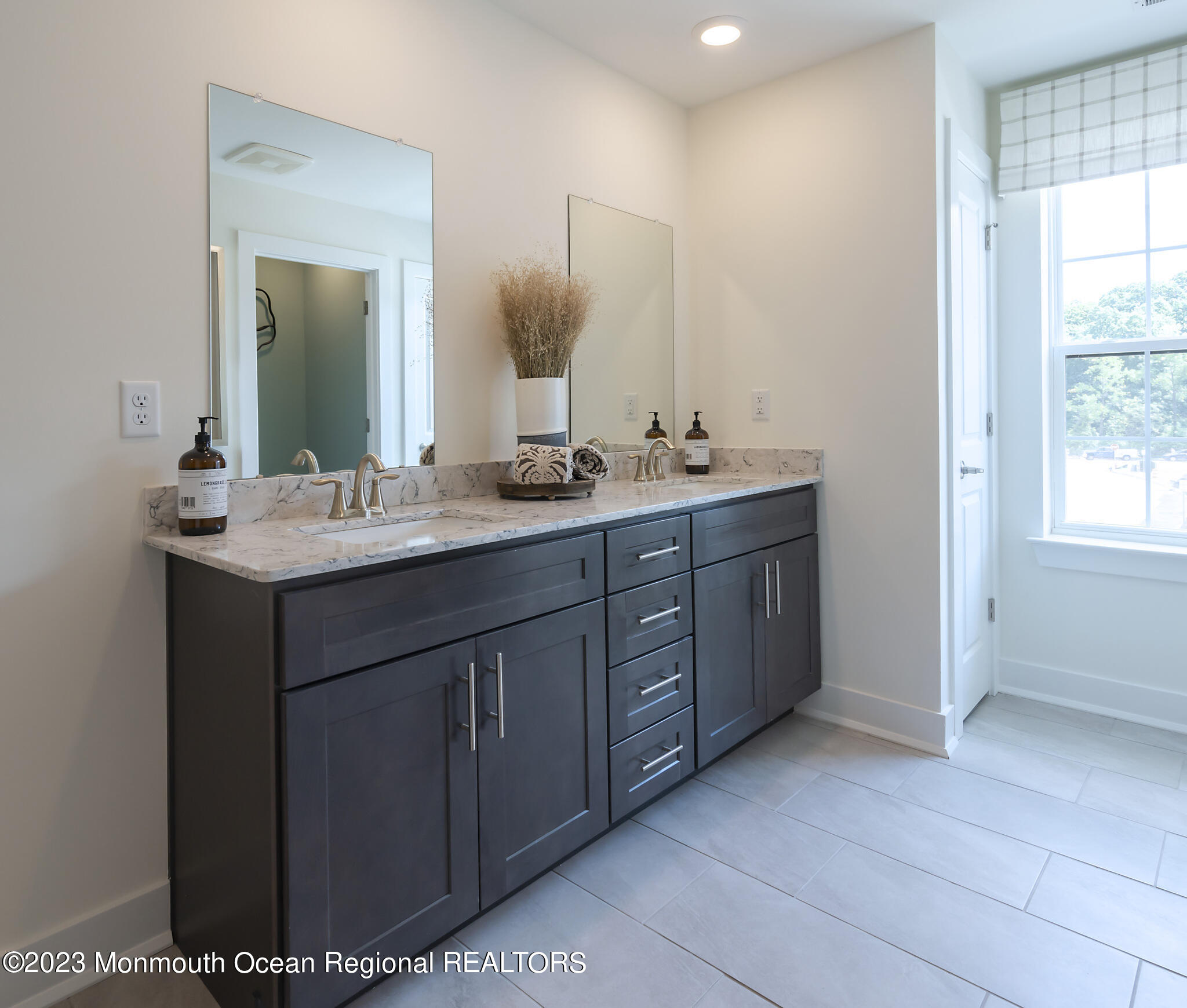 153 Woolley Court Asbury Park, NJ 07712 - Photo 15 of 23 a bathroom with a double vanity sink and mirror