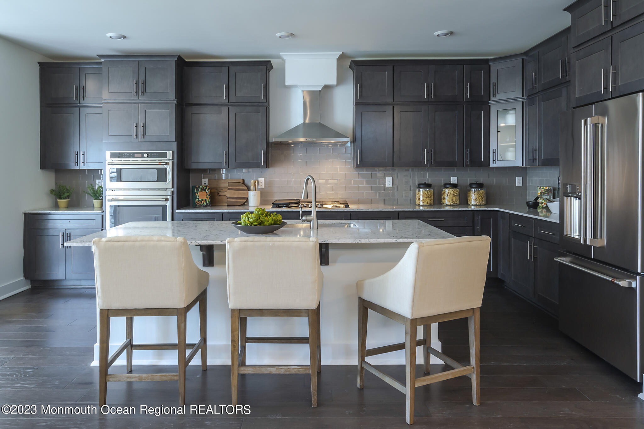 153 Woolley Court Asbury Park, NJ 07712 - Photo 8 of 23 a kitchen with stainless steel appliances granite countertop a dining table chairs refrigerator and sink