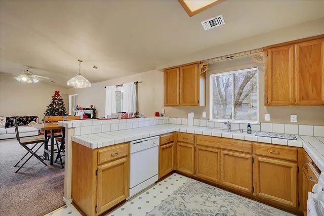 a kitchen with a sink cabinets and window