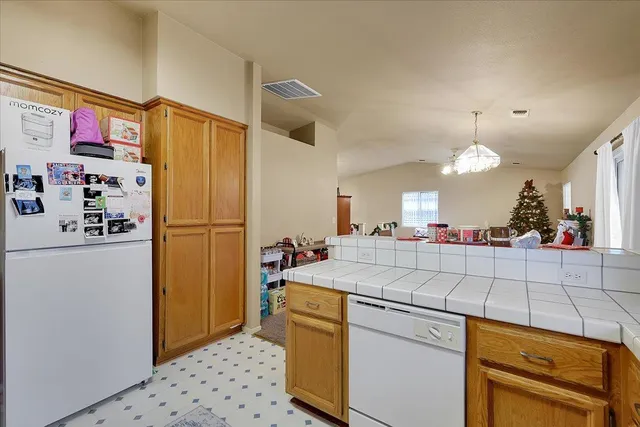 a kitchen with refrigerator and cabinets