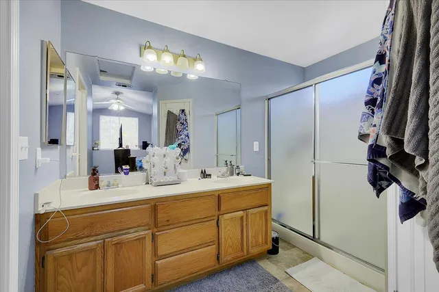 a bathroom with a sink double vanity and a mirror