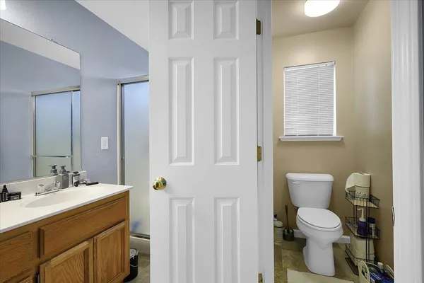 a bathroom with a toilet sink and mirror
