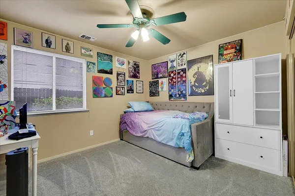 a bedroom with a bed and a window