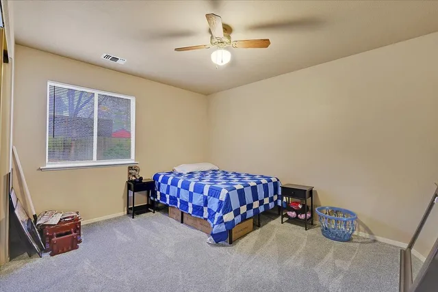 a room with a bed and a chandelier