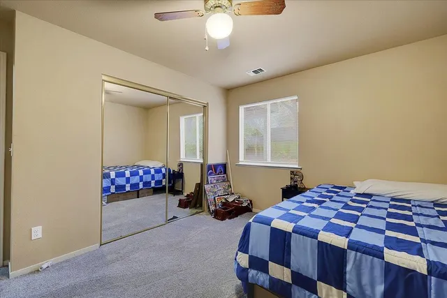 a bedroom with bed and a chandelier