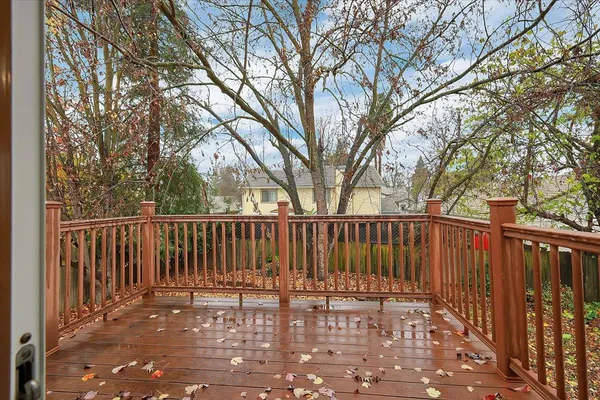 a view of street with wooden fence and trees