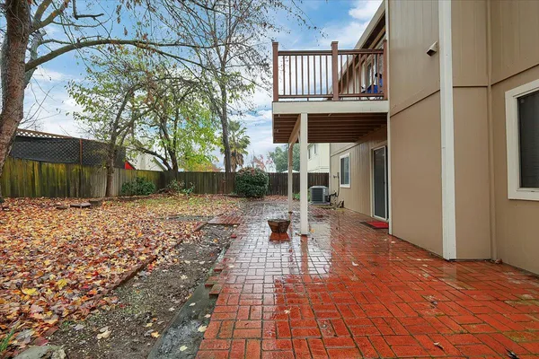 a view of a house with backyard and sitting area