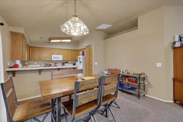 a view of a dining room with furniture and a chandelier