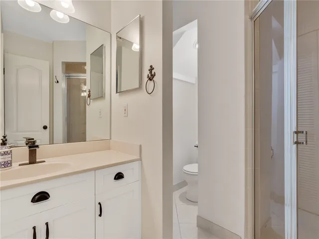 a bathroom with a sink mirror and shower
