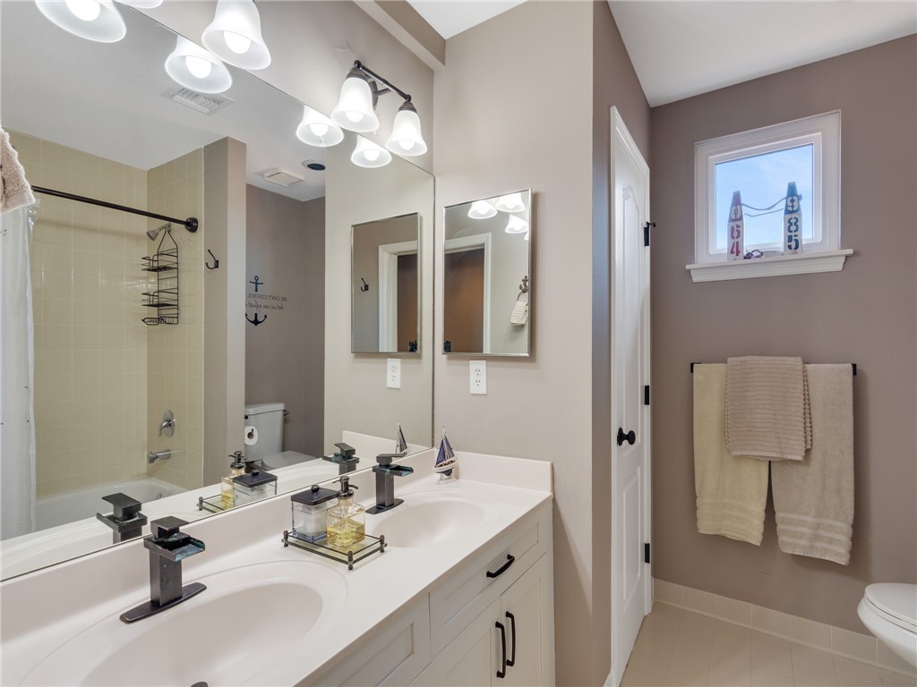 1370 St Davids Lane Vero Beach, FL 32967 - Photo 20 of 36 a bathroom with a sink a light fixture and a mirror