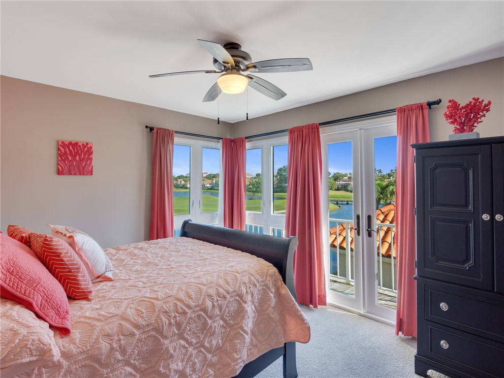 1370 St Davids Lane Vero Beach, FL 32967 - Photo 23 of 36 a bedroom with a bed and a chandelier
