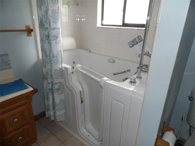 a bathroom with a bathtub and shower