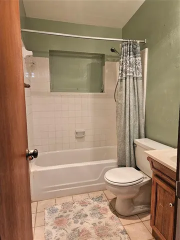 a bathroom with a toilet and shower