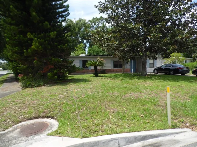 a view of a house with backyard porch and sitting area