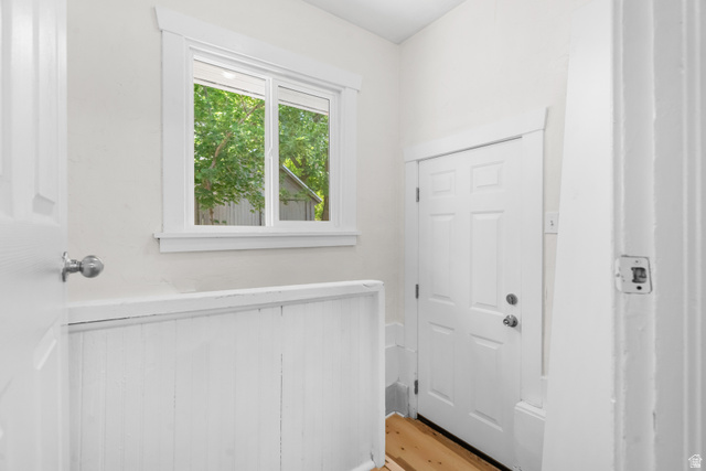 2862 Fowler Avenue Ogden, UT 84403 - Photo 17 of 23 Entryway featuring a paneled door, wood-finish flooring, and a window with white trim