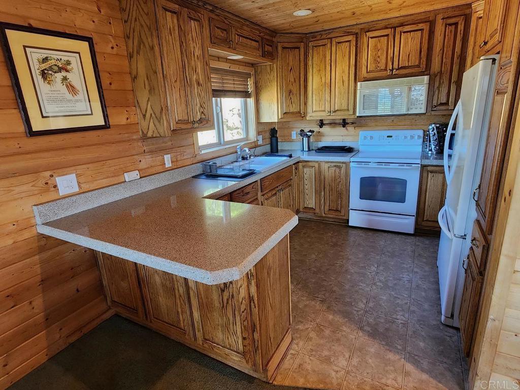 34675 Yuma Road Julian, CA 92036 - Photo 8 of 28 a kitchen with stainless steel appliances granite countertop a sink a stove and a refrigerator