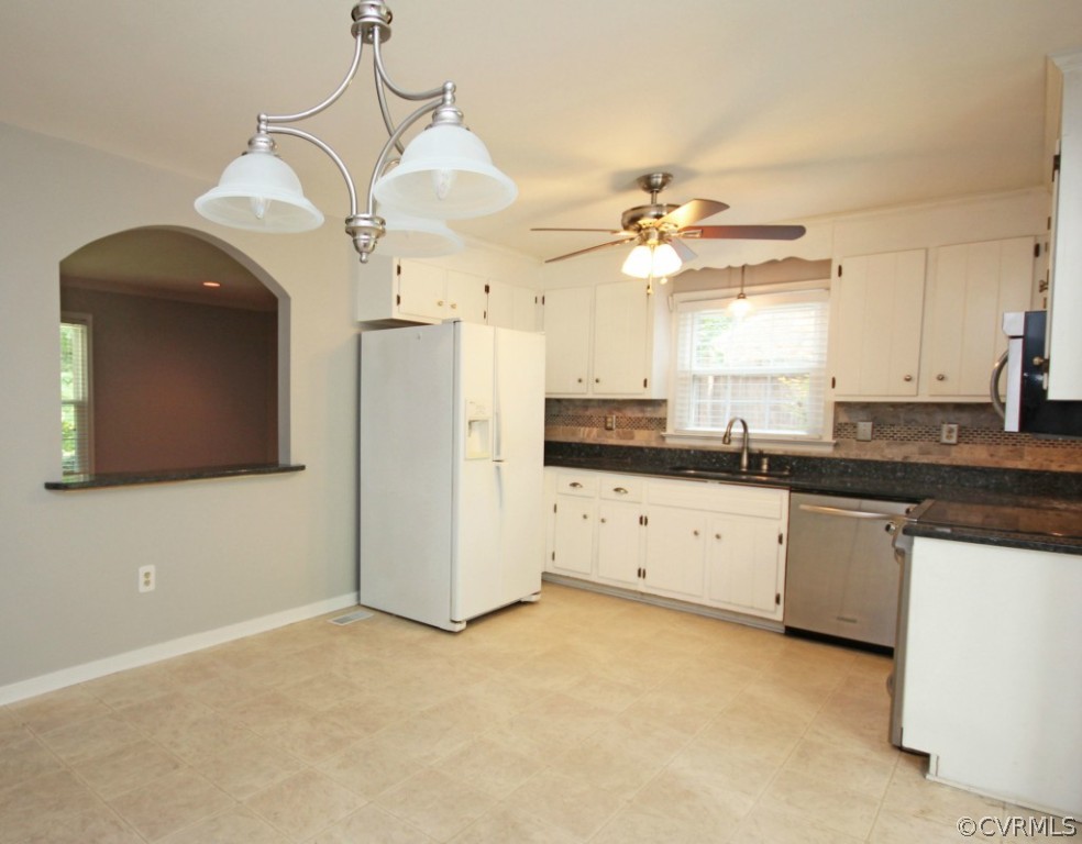 15321 Beach Road Chesterfield, VA 23838 - Photo 5 of 23 a kitchen with a refrigerator a sink and dishwasher with white cabinets