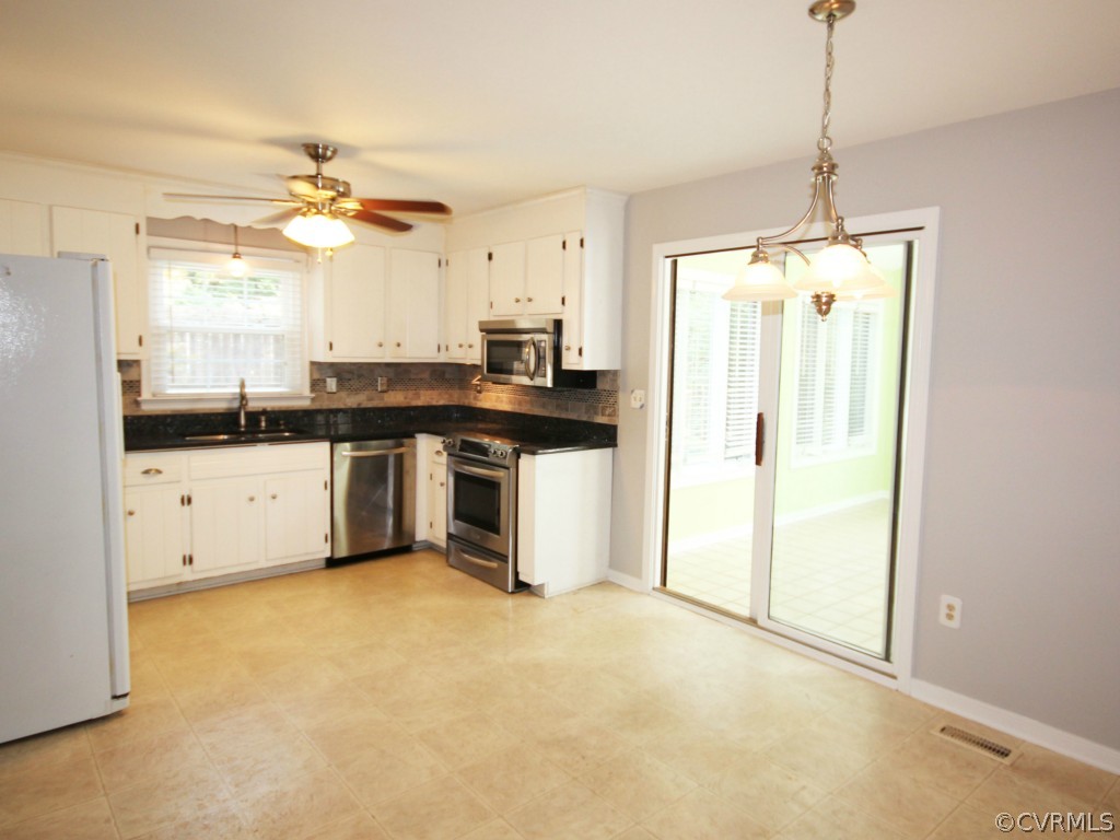 15321 Beach Road Chesterfield, VA 23838 - Photo 6 of 23 a kitchen with stainless steel appliances a stove a sink a refrigerator a window