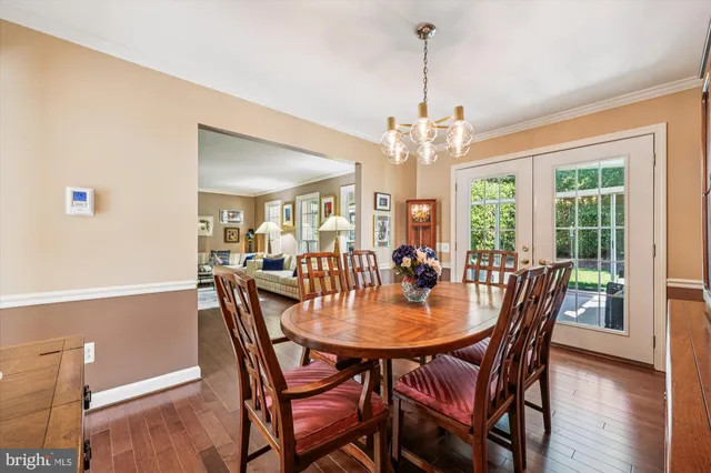 a dining room with furniture window and wooden floor