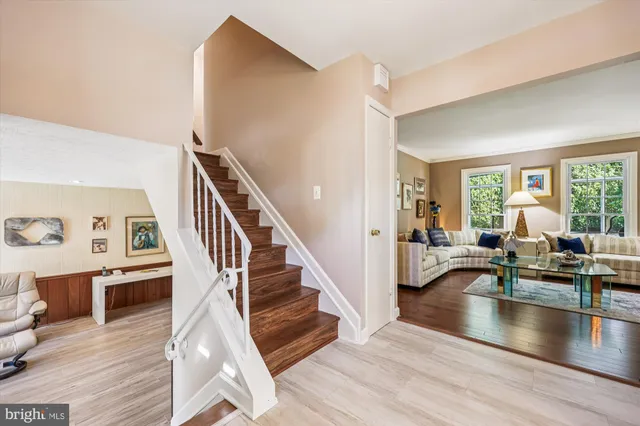 a living room with lots of furniture and a wooden floor