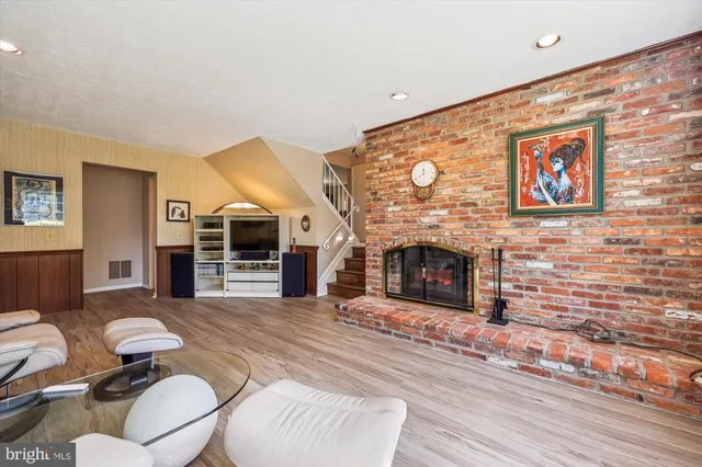 a living room with furniture a fireplace and a flat screen tv