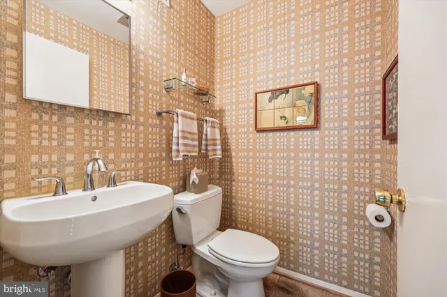 a bathroom with a sink toilet and mirror