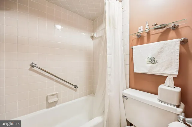 a living room with furniture and a book shelf
