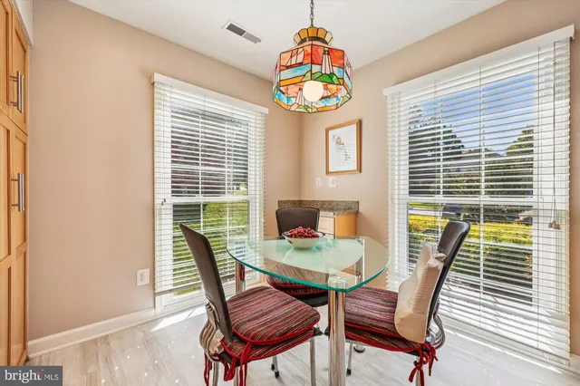 a dining room with furniture and a window