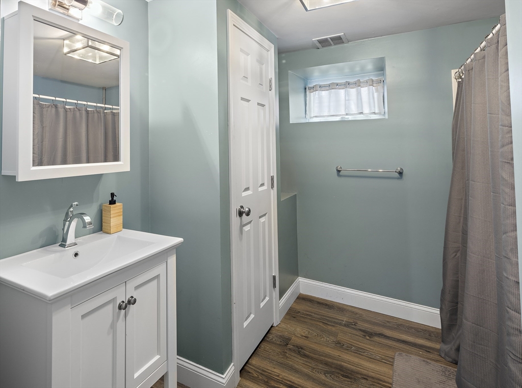 3 Clinton Road Revere, MA 02151 - Photo 12 of 19 a bathroom with a sink a mirror and a shower