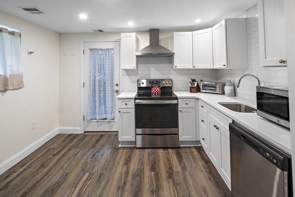 3 Clinton Road Revere, MA 02151 - Photo 16 of 19 a kitchen with a sink a stove and cabinets